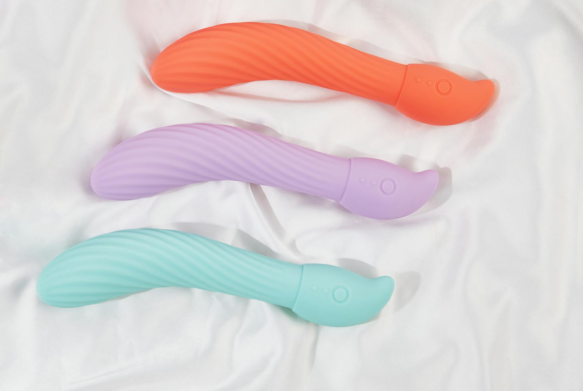 Yellow silicone lemon vibrator surrounded by fresh bananas on a bright yellow background
