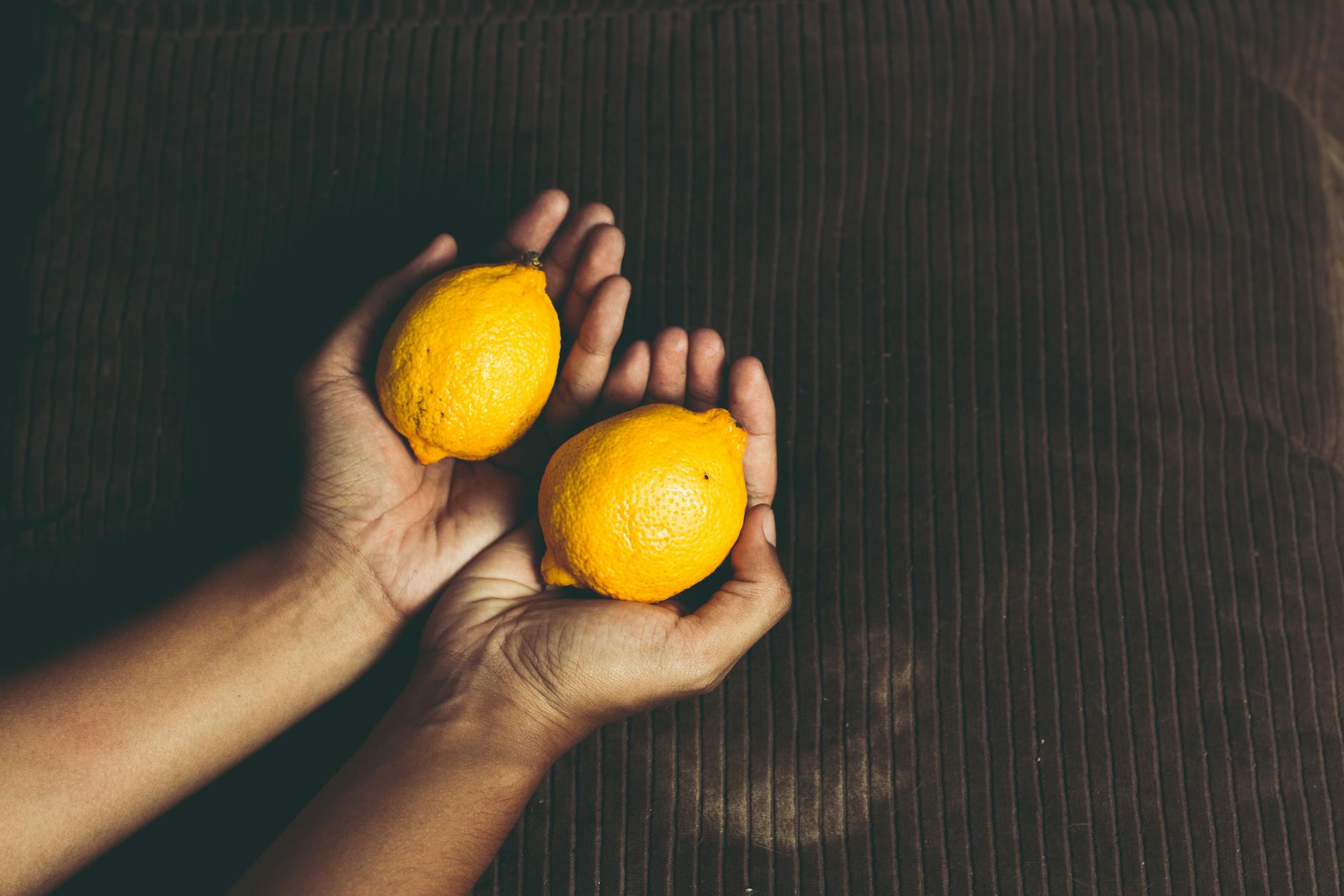 Bright vivid lemons on a yellow background, representing the fresh sensation changes after quitting hormonal birth control