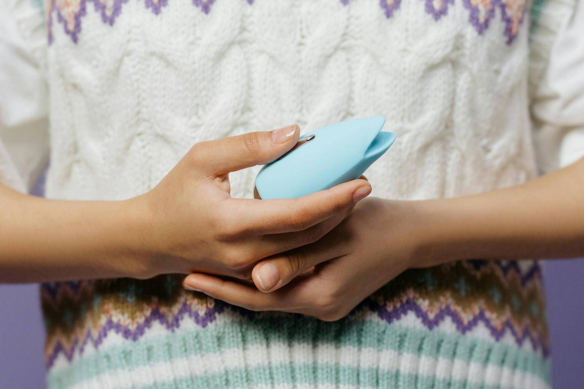 Hands holding a personal massager, showing comfort and intimacy between partners